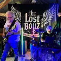 The Lost Boyz on stage in front of their winged backdrop.