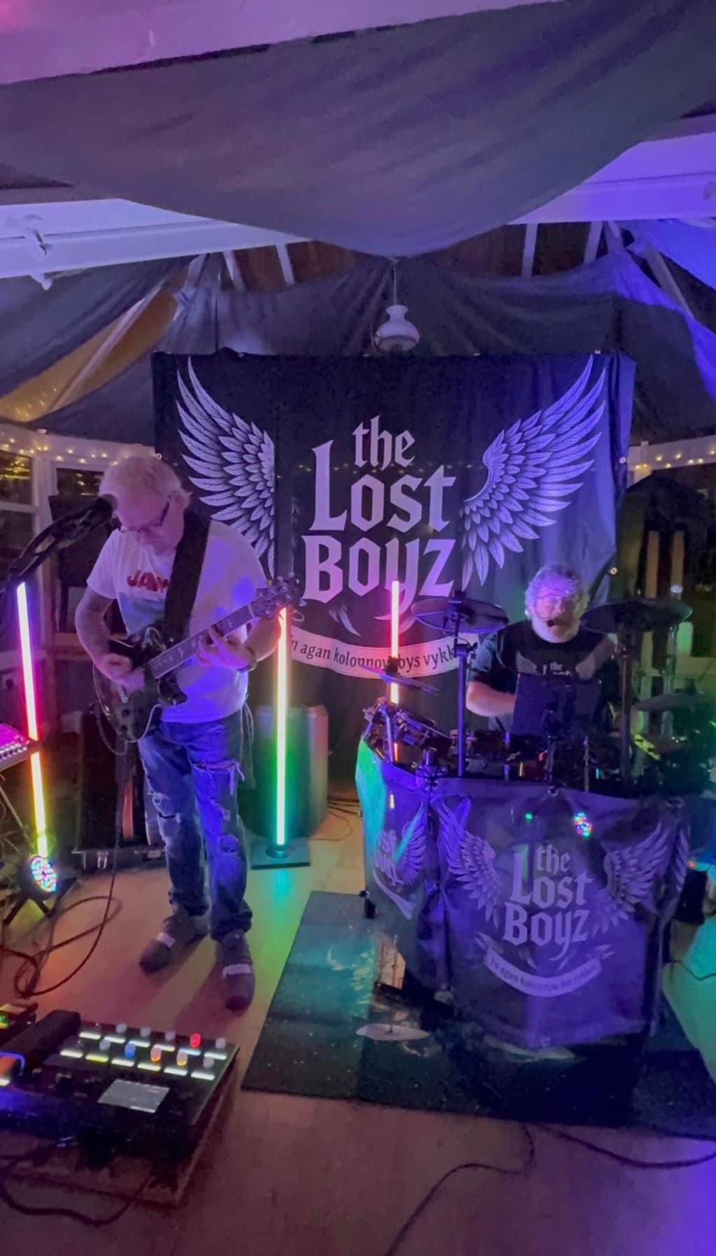 The Lost Boyz on stage in front of their winged backdrop.
